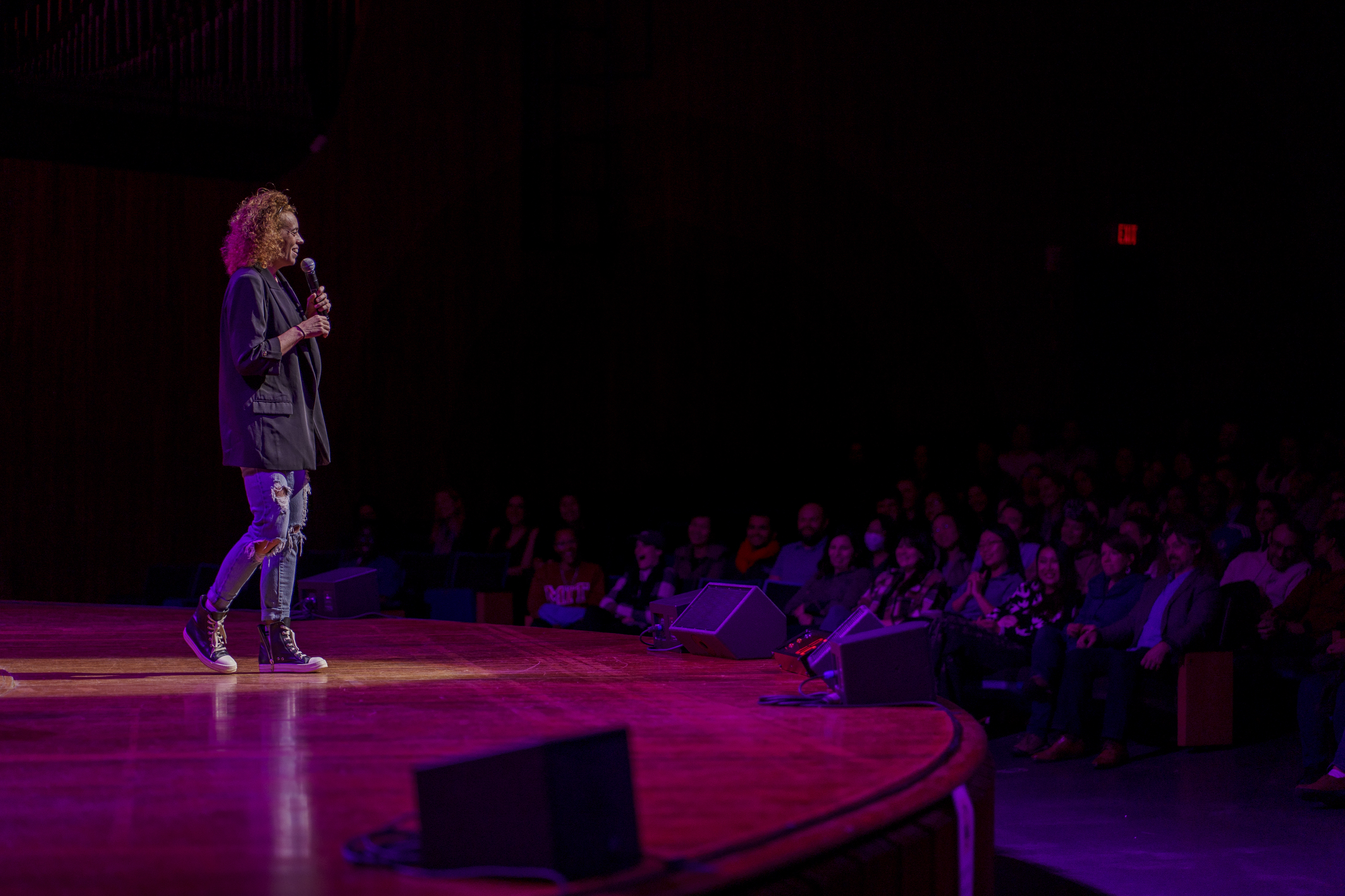 Michelle Wolf performing on stage at Kresge Auditorium
