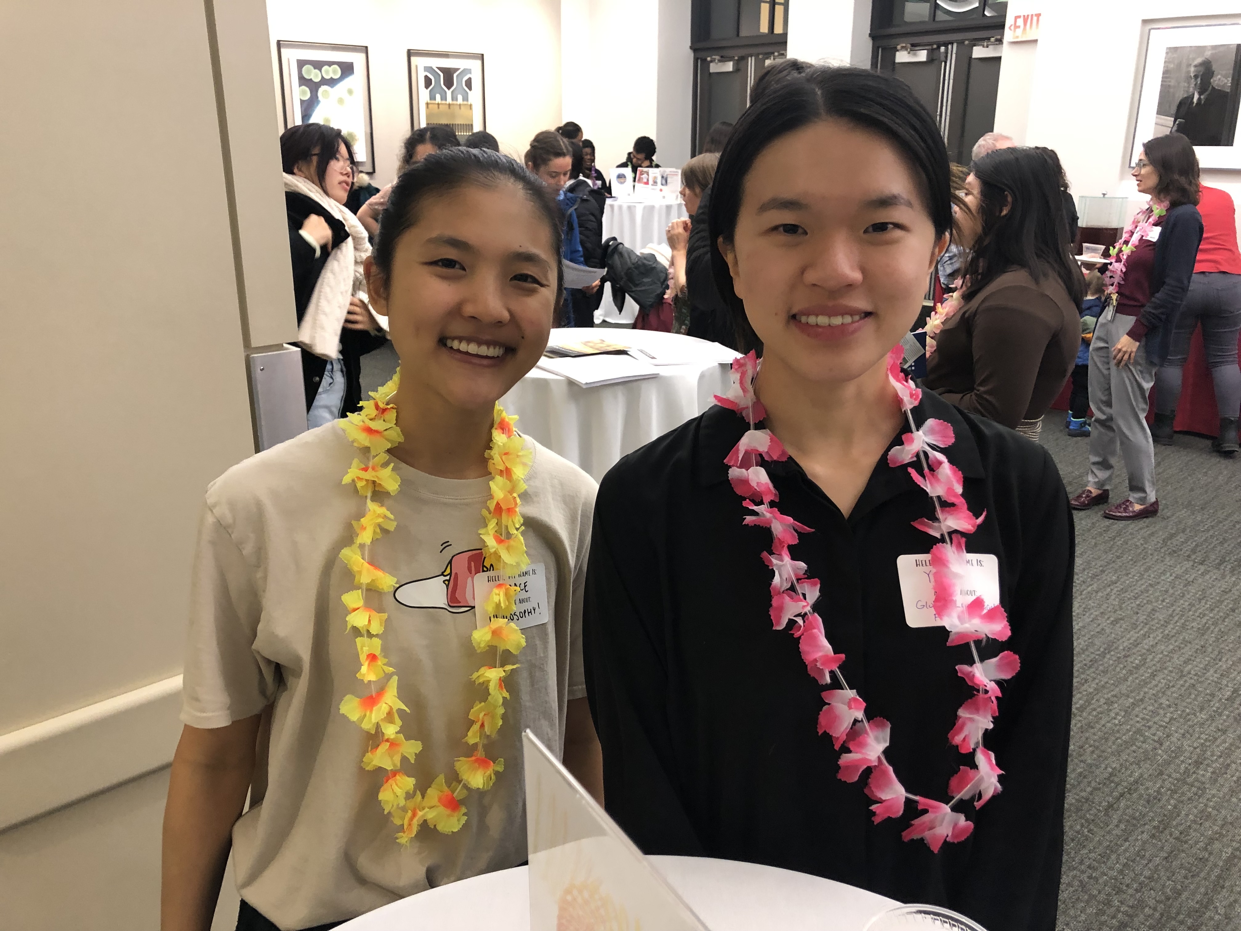 Two smiling students wear leis during the Spring Ahead with SHASS event