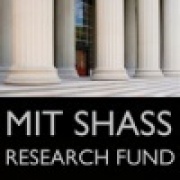 White columns outside of Building 10 with the words "MIT SHASS Research Fund" underneath