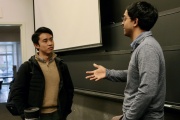 Professor Ashesh Rambachan (right) confers with Jimmy Lin, an economics doctoral student, following an Algorithms and Behavioral Science class. The new course’s goals are both scientific (to understand people) and policy-driven (to improve society by improving decisions).