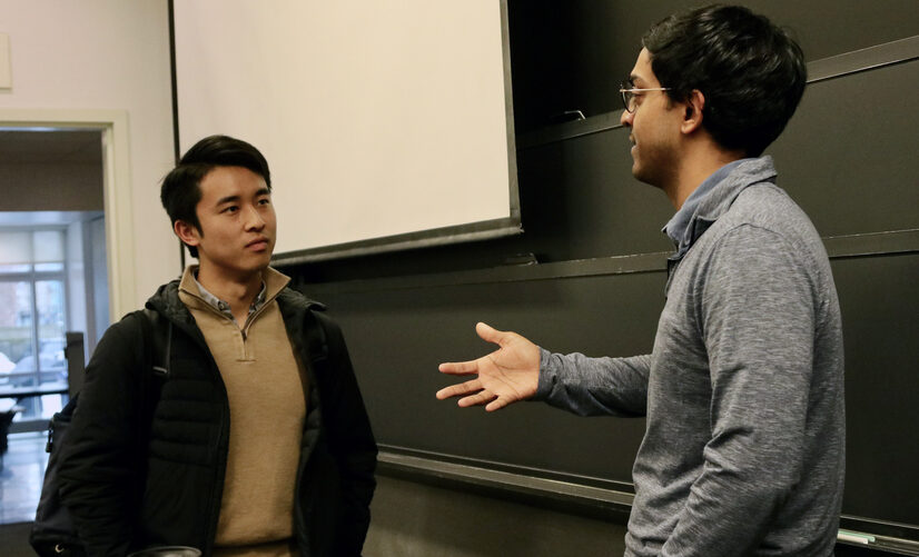 Ashesh Rambachan (right) and Jimmy Lin discuss the day's lesson following the class 14.163 (Algorithms and Behavioral Science)