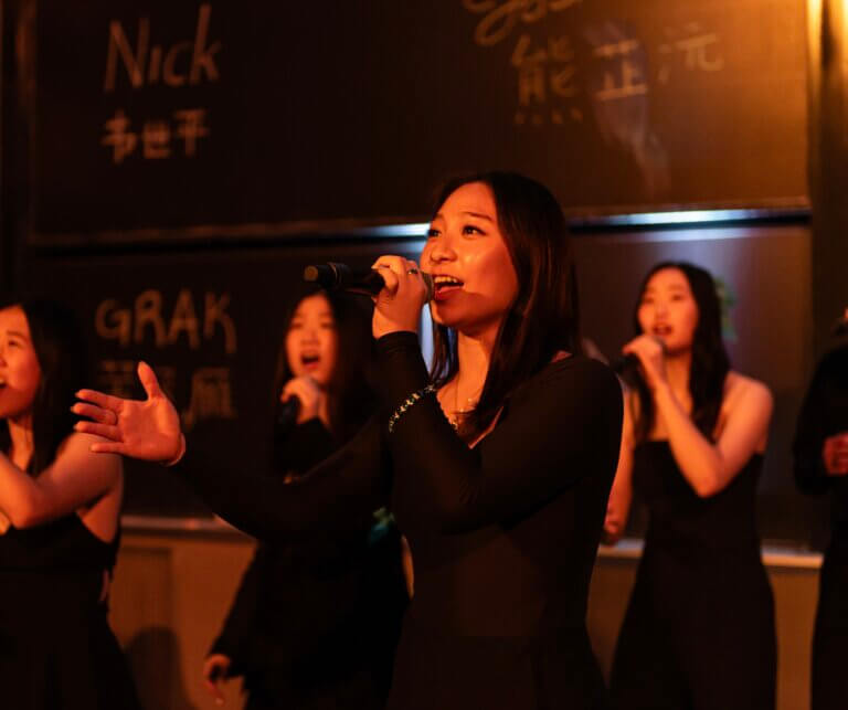 Rachel Loh singing (center)