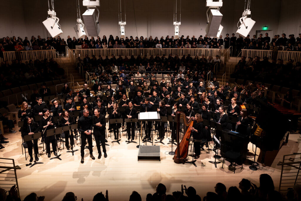 The world premiere of Praeordinatus Ut Astra Sacrificia Nostra ("Fore-Ordained As Stars Our Sacrifices") by MIT alumnus and Tony Award-winning composer Jamshied Sharifi. Sharifi is pictured in the front row on the left with Frederick Harris, Jr.