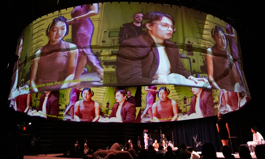A large circular paper projection surface used during the performance of the Stan Lai play "A Dream Like A Dream" measured 10 feet high by 40 feet wide and was suspended above the stage.
